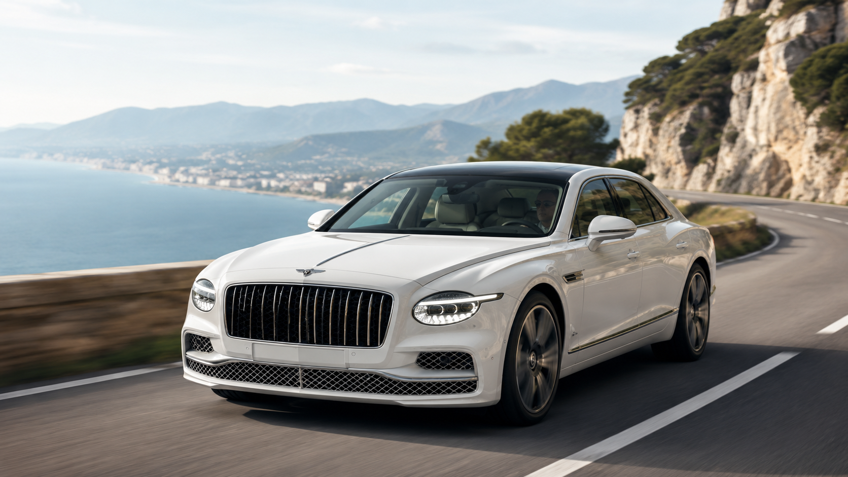 Новый белый Bentley Flying Spur 2026 на живописной дороге у побережья